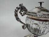 a silver cup with a lid on a stand