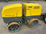 a yellow and black road roller parked on the side of the road
