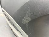 a close up of a car ' s front door with a dirty window