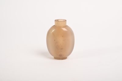 a small glass vase sitting on a white surface