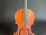 an old violin is sitting on top of a black surface