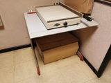 a pizza oven sitting on top of a table next to a cardboard box