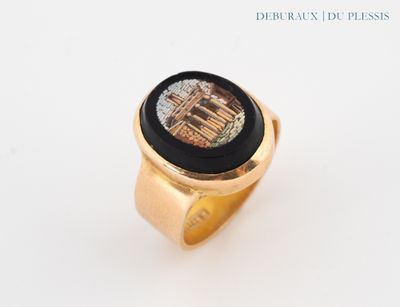 an image of a gold ring with a black stone in the center