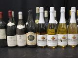 many bottles of wine lined up on a table