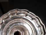a silver vase that is sitting on a table