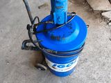 une borne d'incendie bleue posée par terre à côté d'un tas de bouteilles