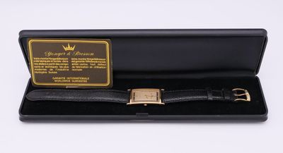 une montre noire dans un écrin noir avec un fermoir plaqué or