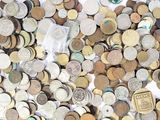 a pile of coins that are on a white surface