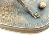 a bronze statue of a bird with a feather on it ' s feet