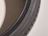 a close up of a tire on a white surface with a black rim