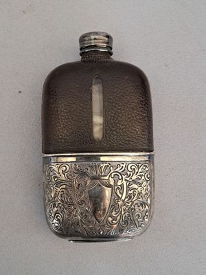 a flask with a shield on it sitting on a table