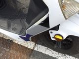 a scooter that is parked on the side of the street