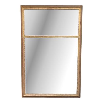 a gold framed mirror on a white wall with a white background