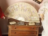 two dolls that are standing next to a dresser