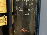 two bottles of wine that are sitting on a table
