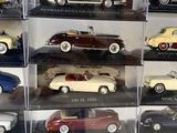 a lot of different models of cars in a display case