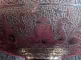 a metal bowl with a design on it on a table