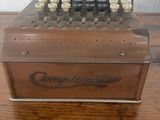 an old fashioned cash register sitting on top of a wooden table