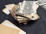 a pile of old postcards on a table next to a pile of old postcards