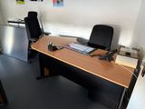 a desk with a chair and a phone on it