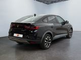 the rear end of a black car in a white room