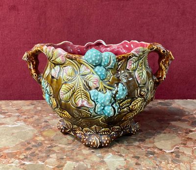 a vase that is sitting on a table with a red background