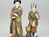 two asian figurines of a woman and a man in kimono robes
