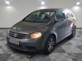 a picture of a grey car parked in a garage