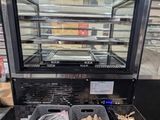 a display case with a lot of food inside of it