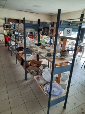 une pièce remplie de nombreuses étagères sur lesquelles sont disposées des assiettes