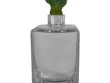 a close up of a glass vase with a plant inside of it
