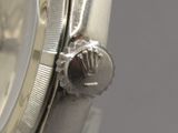 a close up of a watch with a silver face