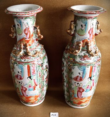 two vases that are sitting on a brown surface