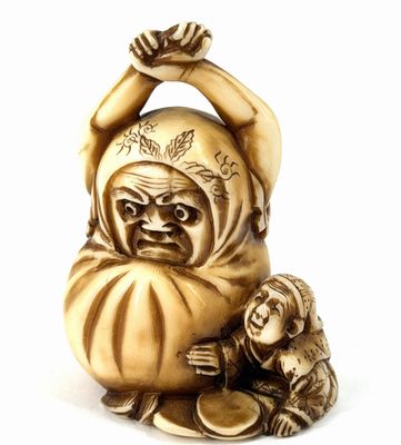 a small statue of a man holding a baby