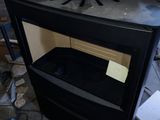 a black stove with a cardboard box on top of it