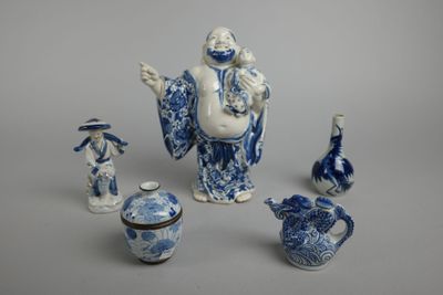 a group of blue and white porcelain figurines and vases
