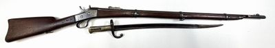 pair of old guns hanging on a hook on a wall