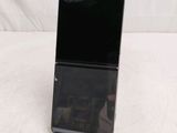 the back of a black cell phone sitting on top of a table