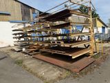 a large pile of wooden planks sitting on the side of the road