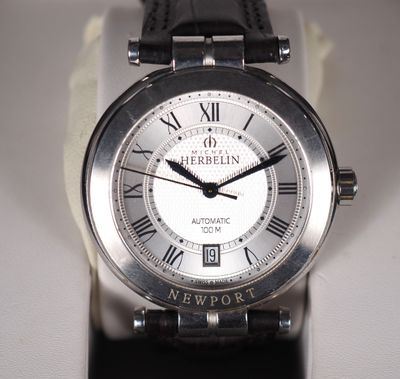 a close up of a wrist watch with roman numerals