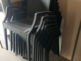 a lot of chairs that are stacked up against the wall
