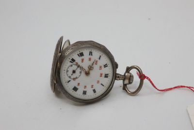 a silver pocket watch with roman numerals on it
