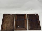 three wooden trays with blue string on them sitting on a white surface