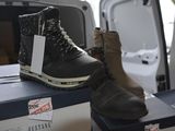 a pair of boots sitting on top of a box in the back of a van