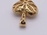an image of a gold brooch with diamonds on a white surface