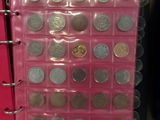 a pink binder with a bunch of coins in it