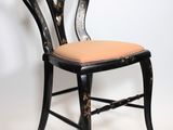 an image of a black and gold chair with a pink seat
