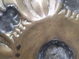 a close up of a metal object with a flower design