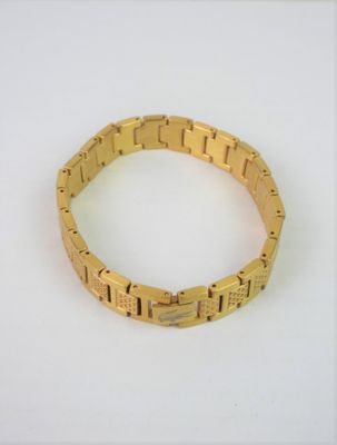 yellow gold plated bracelet on a white surface with a white background