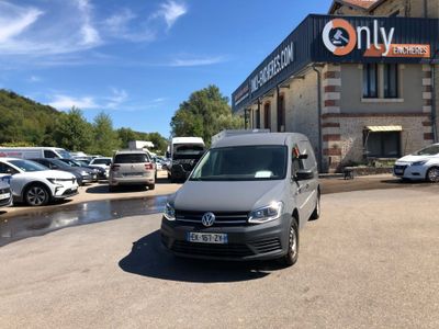 the van is parked in front of the building with many cars parked in front of it